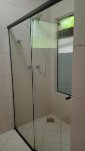 a shower with a glass door in a bathroom at Blu Hostel in Blumenau