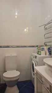 a bathroom with a toilet and a washing machine at Rehouse, Antokolskio 13 in Vilnius +20 photos