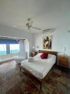 a bedroom with a bed and a chair and a window at Bungalow Calma La Roca 59 in Torremolinos