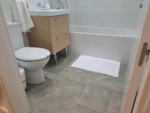 a bathroom with a toilet and a sink and a shower at Main Street - 3 Bed Room - Family Friendly in Gibraltar