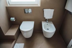 a small bathroom with a toilet and a bidet at Al Pescatore - B&B in Bari