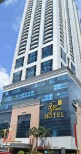 a large building with a hotel sign on it at BSA TWIN TOWER in Manila