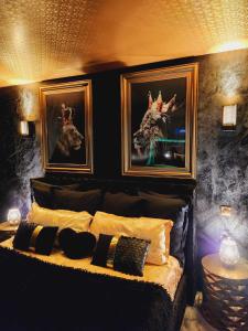 a bedroom with a bed with two pictures on the wall at Maloveroom, 2 Suites d'exceptions in Beaucroissant +43 photos