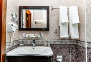 a bathroom with a sink and a mirror at Bagizagan Hotel in Samarkand +150 photos