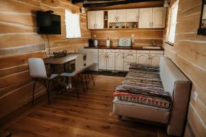 a kitchen with a desk and a table in a cabin at Magaze de Luxe in Gradačac