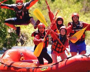 a group of people are rafting on a river at Complejo Balloffet in San Rafael