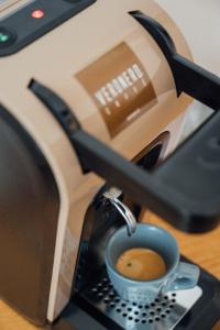 a coffee machine is making a cup of coffee at Al Pescatore - B&B in Bari