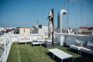 a balcony with couches and tables on a roof at Al Pescatore - B&B in Bari