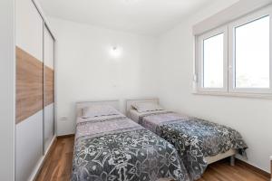 Posteľ alebo postele v izbe v ubytovaní Apartments Boomerang