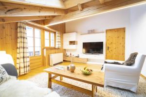 a living room with a table and chairs and a living room at Chasa Sur Chafarrer in Scuol