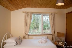 Postel nebo postele na pokoji v ubytování Essex Lodge