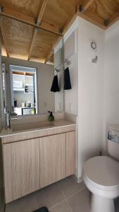 a bathroom with a toilet and a sink at Elegante Loft en Chapinero! 401 in Bogotá