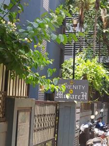 a sign in front of a building with a street sign at Hotel Serene Viman Nagar in Pune