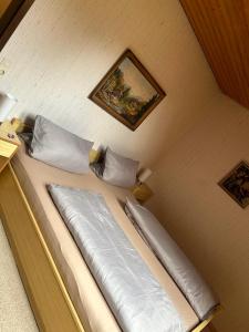 a bed in a room with a picture on the wall at Birke 9, 10 oder 11 in Todtmoos