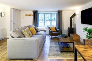 a living room with a couch and a table at Porthallow in Budock Water