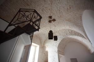 a chandelier hanging from a ceiling in a room at Martine Dimore Storiche di Puglia in Martina Franca