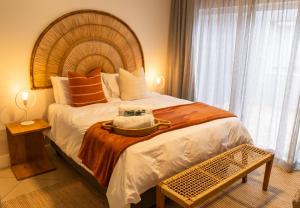a bedroom with a large bed with a hat on it at Deja Blue Beachfront Villa, Newly renovated in Langstrand