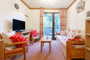 a living room with a couch and a tv at Appart valfrejus in Modane