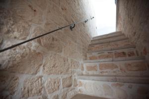 a staircase in a stone building with a window at Martine Dimore Storiche di Puglia in Martina Franca