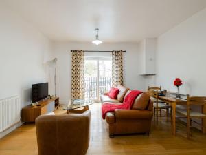 a living room with a couch and a table at Pass The Keys - Homely flat in east London with sunny Balcony in London