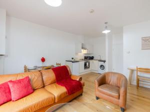 a living room with a couch and a chair at Pass The Keys - Homely flat in east London with sunny Balcony in London