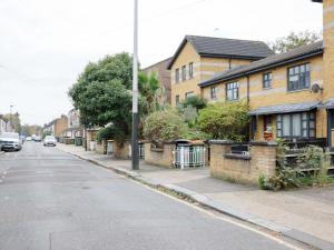 an empty street with houses on the side of the road at Pass The Keys - Homely flat in east London with sunny Balcony in London