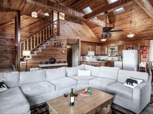 a living room with a couch and a table at Enchanted Oak Cabin in Ruidoso