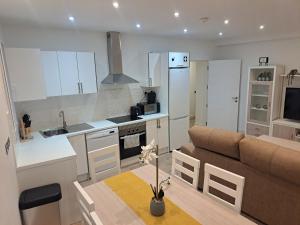 a kitchen and living room with a couch and a table at Main Street - 3 Bed Room - Family Friendly in Gibraltar
