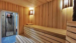 a sauna with wood paneled walls and a bench at Ліс&More in Glebovka