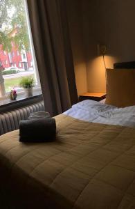 a bedroom with a large bed with a window at Steel Hotel in Smedjebacken