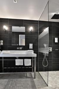 a bathroom with a sink and a mirror at KYRIAD Périgueux - Boulazac in Saint-Laurent-sur-Manoire