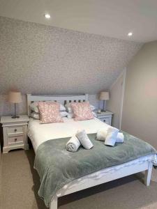 a bedroom with a large bed with pillows on it at Prior House Farm in Berwick-Upon-Tweed