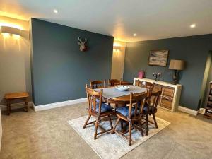 a dining room with a wooden table and chairs at Prior House Farm in Berwick-Upon-Tweed