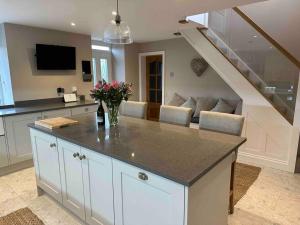 a kitchen with a counter and a living room at Prior House Farm in Berwick-Upon-Tweed