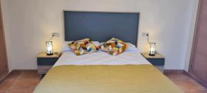a bed with two pillows on top of it at Apartamento Calamina in Riópar