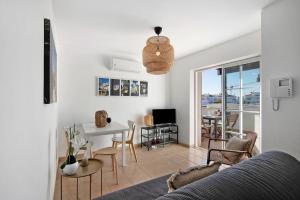 a living room with a table and a dining room at Tavira Mar in Cabanas de Tavira