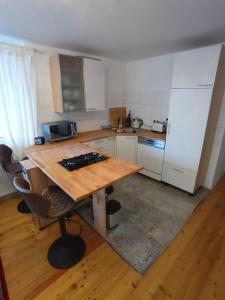 a kitchen with a wooden table and a counter top at Balingen Apartment in Balingen