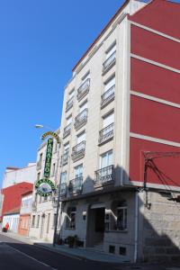 a building with a sign on the side of it at Hotel Paraíso Del Marisco in O Grove