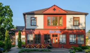 a building with an orange and white building at Jūras Brīze in Ventspils