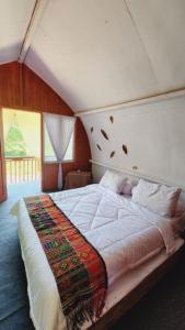 a bedroom with a large bed in a room at homestay noah in Likupang
