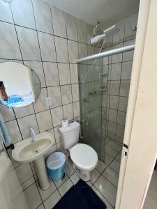 a bathroom with a toilet and a sink and a shower at APARTAMENTO 104- BGMC in Guaibim