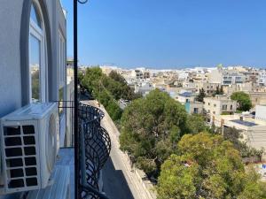 a balcony with a view of a city at Lovely 1-bedroom in St Julians in St Julian's