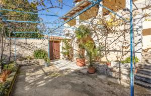 a house with blue scaffolding around a courtyard with potted plants at Lovely Apartment In Bribir in Bribir +24 photos