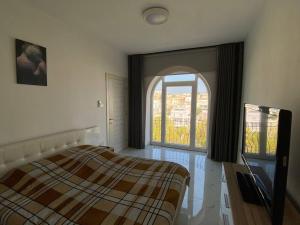 a bedroom with a bed and a large window at Lovely 1-bedroom in St Julians in St Julian's