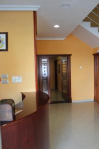 an office lobby with yellow walls and a staircase at Hotel Paraíso Del Marisco in O Grove