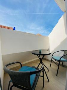 a balcony with two chairs and a table on a roof at FUENGIROLA NEW APART. SWEET&BEACH in Fuengirola