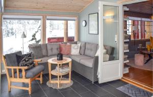 a living room with a couch and a table at Cozy Home In Noresund With Kitchen in Noresund