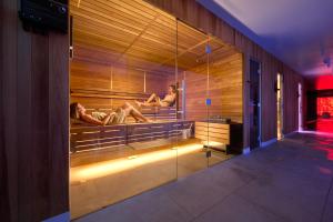 a room with two people laying in a sauna at Grand Hotel View in Postira