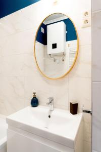 a bathroom with a sink and a mirror at Újbuda Rest Apartment With Air Condition and Balcony in Budapest