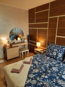a bedroom with a bed and a desk and a mirror at Apartment Svetoslava in Pamporovo